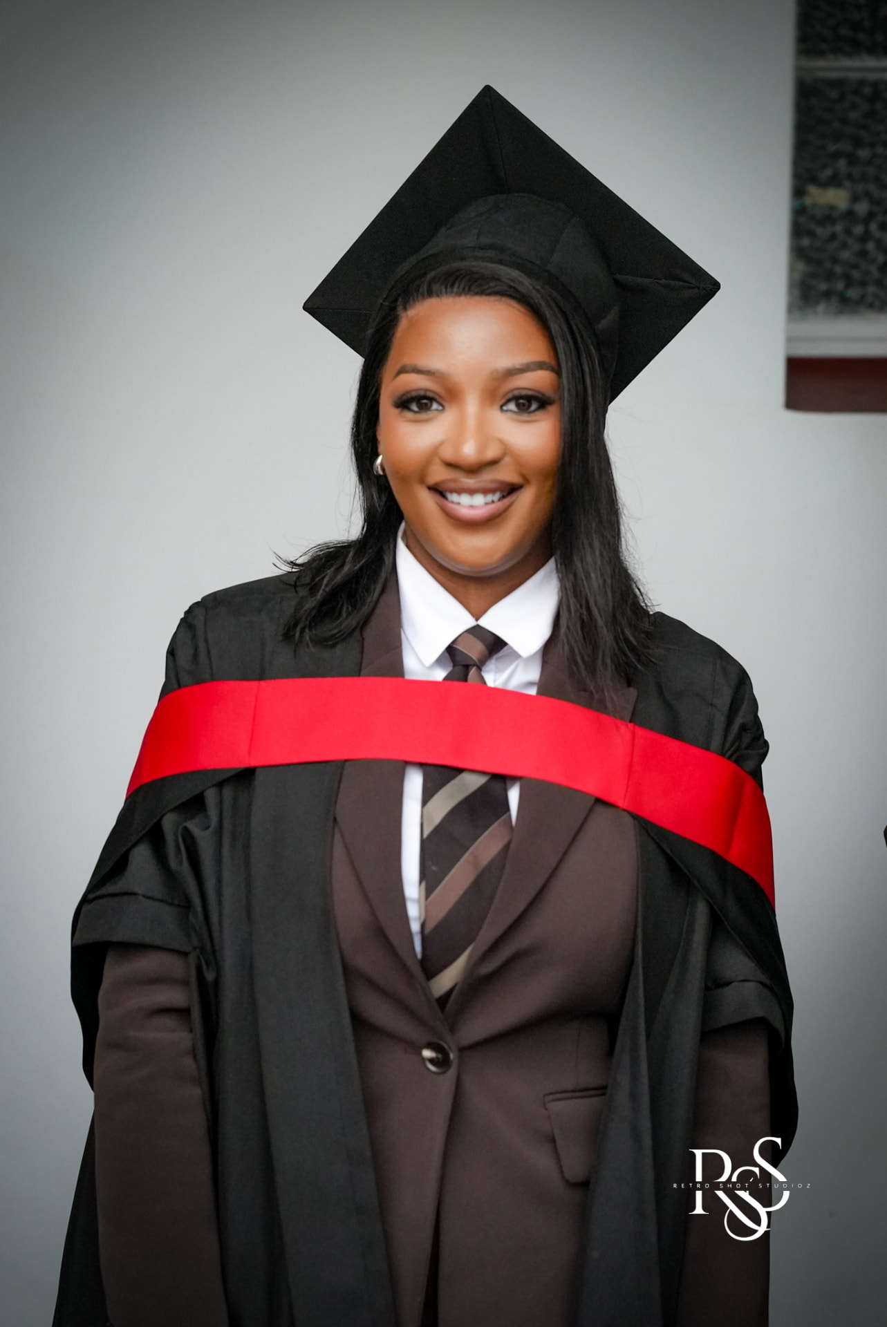 Graduation portrait with red sash