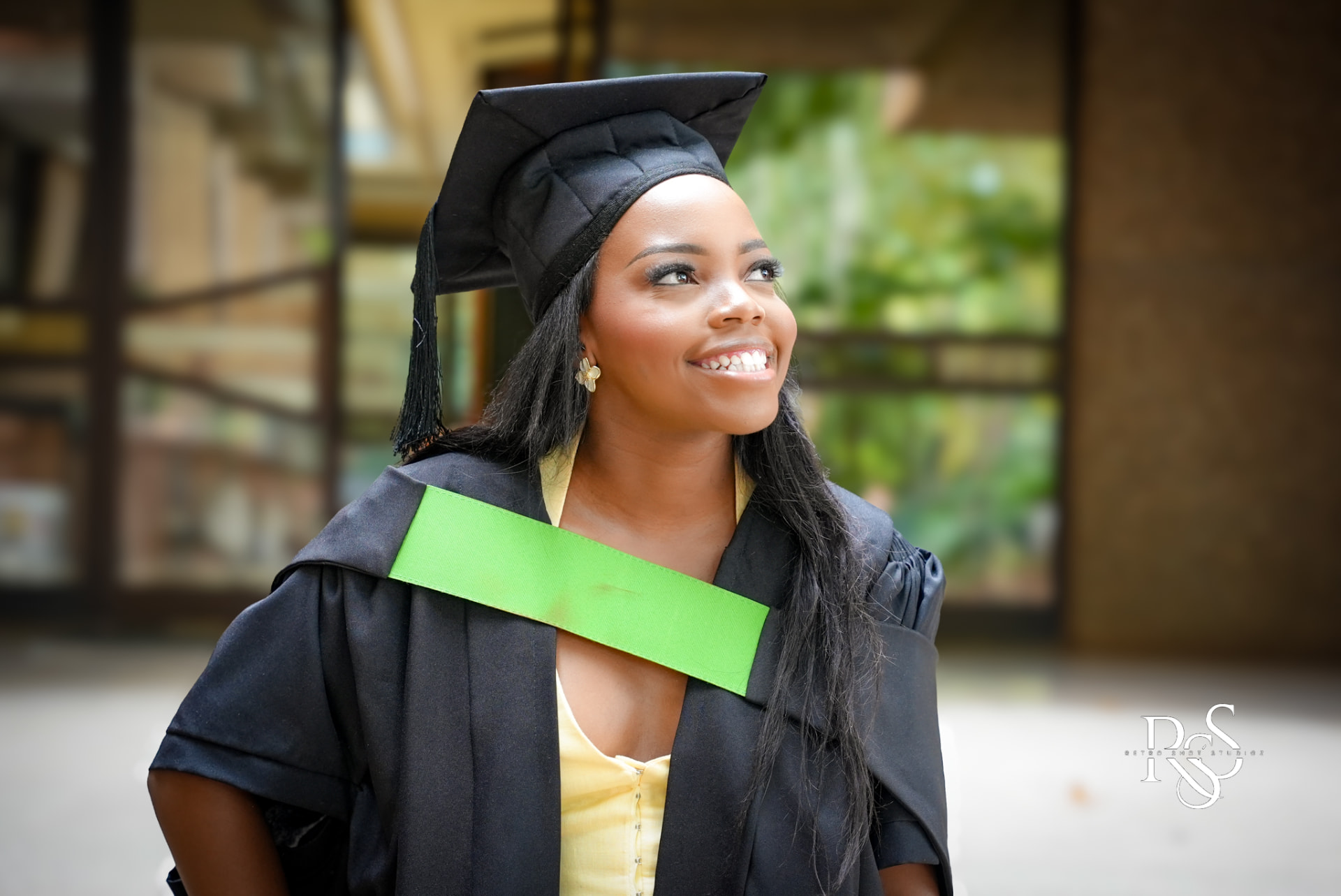NWU graduate smiling in cap and gown